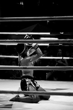 BANGKOK, THAILAND -  OCTOBER 9 : Unidentified fighter first performs the respect(Wai Khru Ram Muay) before fighing in MBK fight night on 9 October 2013 at MBK Center, Bangkok, Thailandのeditorial素材