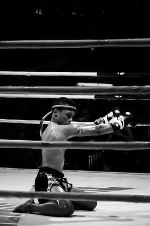 BANGKOK, THAILAND -  OCTOBER 9 : Unidentified fighter first performs the respect(Wai Khru Ram Muay) before fighing in MBK fight night on 9 October 2013 at MBK Center, Bangkok, Thailandのeditorial素材