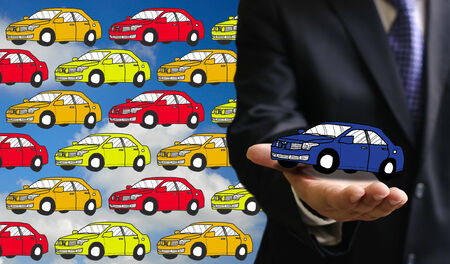 Businessman offer new car in his handの写真素材