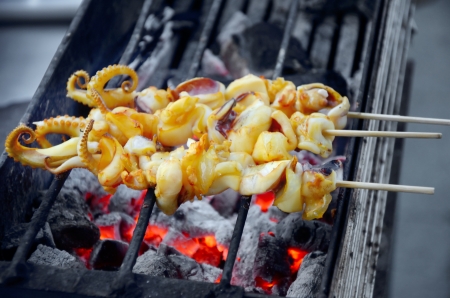Barbecue Squid on hot charcoal stoveの写真素材