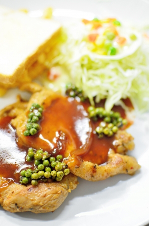 Pork pepper steak with bread and saladの写真素材