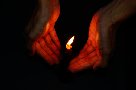 Candle light in hand, Hope conceptの写真素材