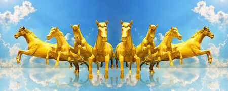 Group of golden horses running on the skyの写真素材