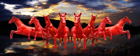 Group of red horses running with sunset sky の写真素材