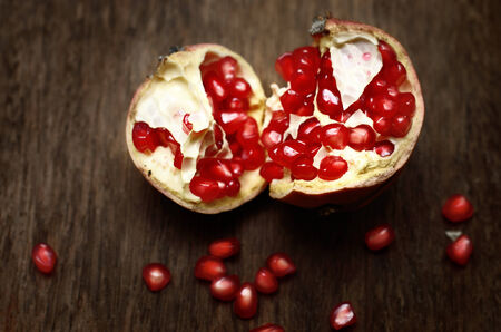 Pomegranate on wooden table, still lifeの写真素材