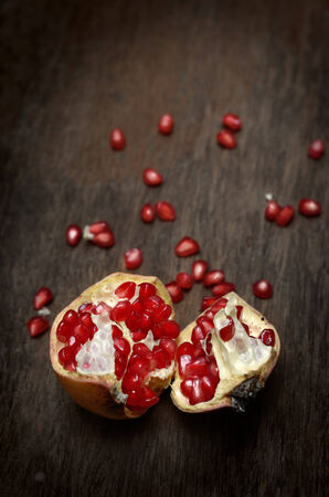 Pomegranate on wooden tableの写真素材
