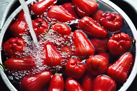 Rose apple in metal bowl with water washingの写真素材