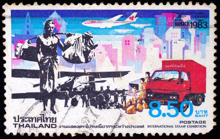 THAILAND - CIRCA 1983: A stamp printed in Thailand shows image of postman working, To commemorate International Stamp Exhibition, circa 1983のeditorial素材