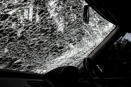 Damaged glass (car windshield) inside carの写真素材