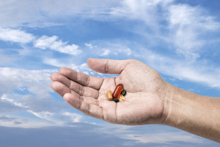 Drug in hand with sky background, Freedom to use drug conceptの写真素材
