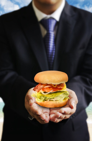 Businessman share food (Hamburger), Share food conceptの写真素材