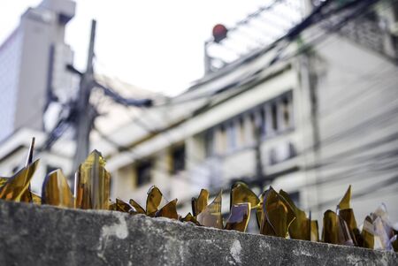 Broken bottles glass on top of fence, Thailandの写真素材