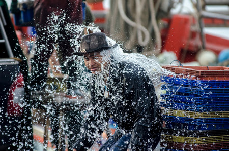 CHONBURI, THAILAND - SEPTEMBER 11 : Unidentified worker of fishing boat washing at jetty on 11...