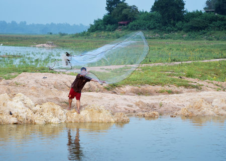 CHONBURI, THAILAND - OCTOBER 20 : Unidentified fisherman throw the net for catch fish in reservoir in 20 October 2015 on Chonburi, Thailandのeditorial素材