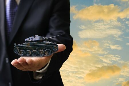 War business concept, Businessman offer war tank in hand