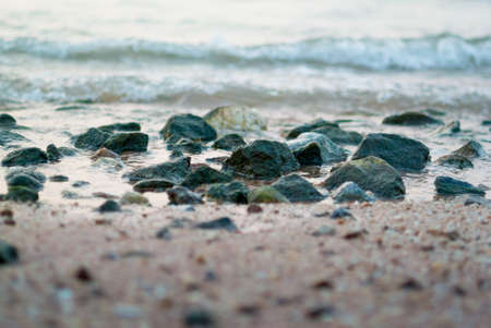 Rock in the sea with surfの写真素材