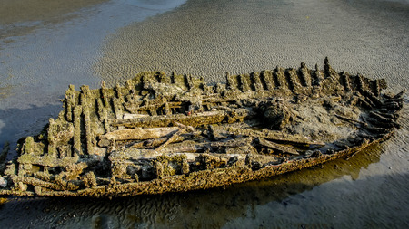 Ancient fishing boat at low tie, Shipwreck with grunge styleの写真素材
