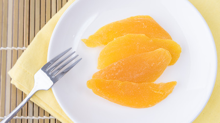 Dried mango in white dish ready to eat (Top view)の写真素材