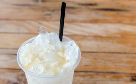 Ice milk on wooden table backgroundの写真素材