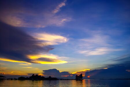 Nice dramatic sky at sea with island silhouetteの写真素材