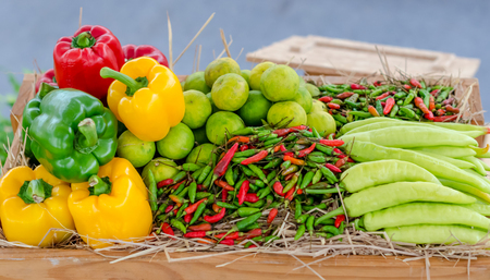 Group of chilli and lime in wooden boxの写真素材