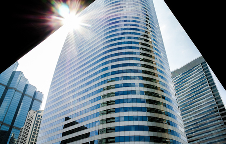 Cityscape with sun flare, Building background with low angle view