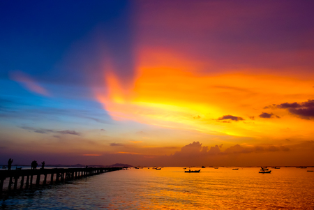 Nice dramatic sky at sea with silhouette of portの写真素材