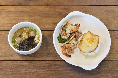 High angle view of Thai food dish, Rice topped with stir-fried seafood and basilの写真素材