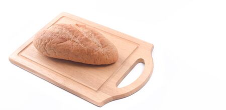 Sourdough Loaf on wooden cutting board isolated on white backgroundの写真素材