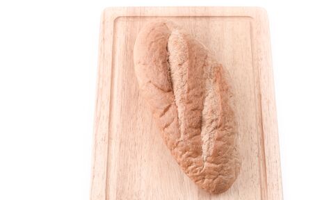 Sourdough Loaf on wooden cutting board isolated on white backgroundの写真素材