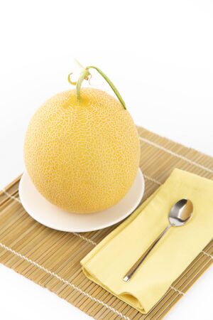 Galia melon ready to eat on white backgroundの写真素材