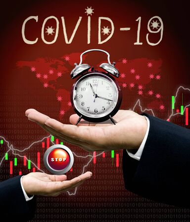Stop Covid-19 pandemic concept, Clock in hand and stop button in hand with world map backgroundの写真素材