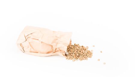 Coffee beans unroasted with paper bag isolated on white background