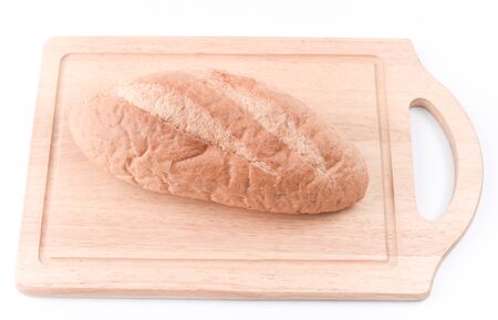 Sourdough Loaf on wooden cutting board isolated on white backgroundの写真素材