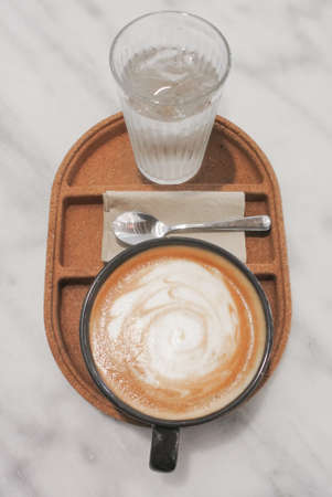 Hot coffee, Latte cup with drinking water on trayの写真素材