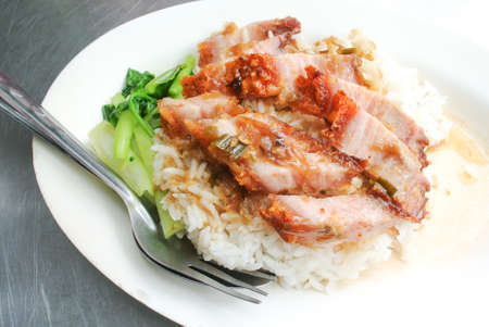 Crispy pork with rice on white dish