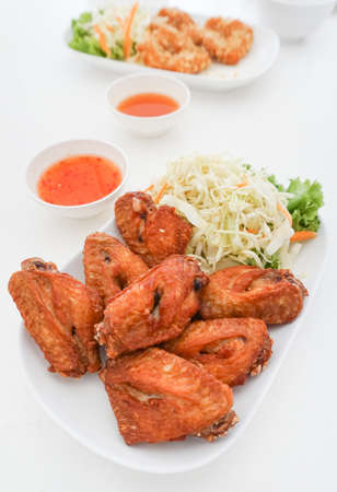 Chicken fried with salad on white dishの写真素材