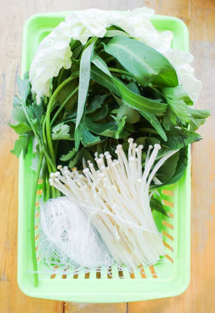 Fresh vegetable with mushrooms in basket ready for cook in hot potの写真素材