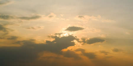 Sunset rays at sky with cloudsの写真素材