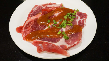 Raw pork in white dish ready for BBQの写真素材