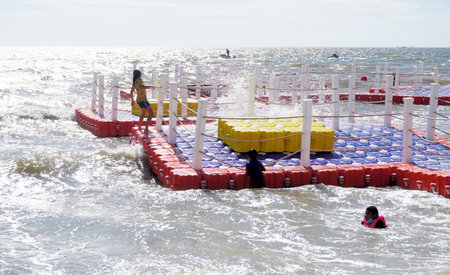 BANGSAEN, THAILAND - 19 FEB : People play with floating pontoon at beach on 19 February 2022 in Bangsaen, Chonburi, Thailandのeditorial素材