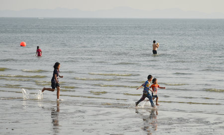 BANGSAEN, THAILAND - 26 FEB : Children run and play at beach in 26 February 2022 in Bangsaen, Chonburi, Thailandのeditorial素材