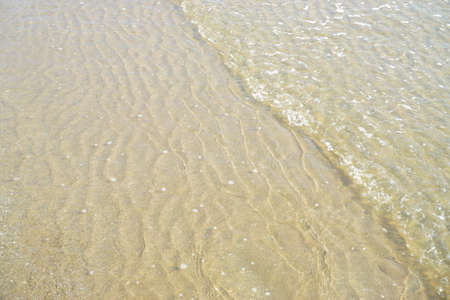 Sea surf and sand background; Nature abstract background
