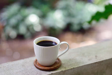 Hot coffee cup on railing, Coffee at homeの写真素材