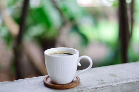 Hot coffee cup on railing, Coffee at homeの写真素材
