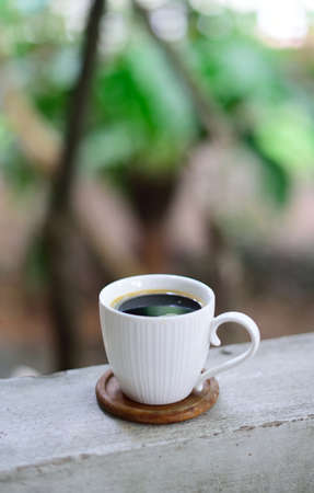 Hot coffee cup on railing, Coffee at homeの写真素材