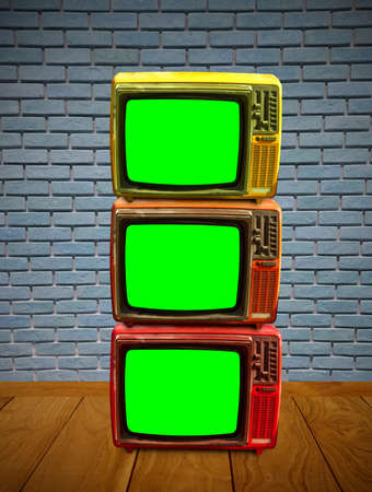 Group of television with green screen on wooden floorの写真素材