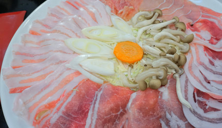 Raw pork and mushroom for boil in hot potの写真素材