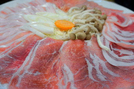 Raw pork and mushroom for boil in hot potの写真素材
