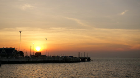 Sunset at sea with silhouette of park beside sea, Chonburi, Thailandの写真素材